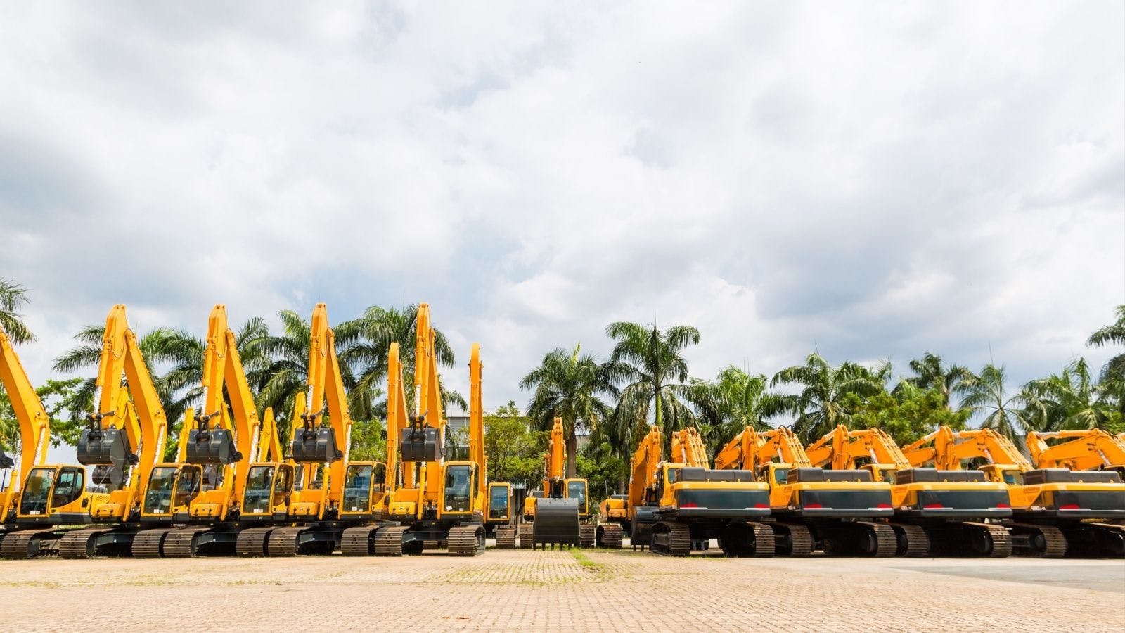 a fleet of construction vehicles in a row