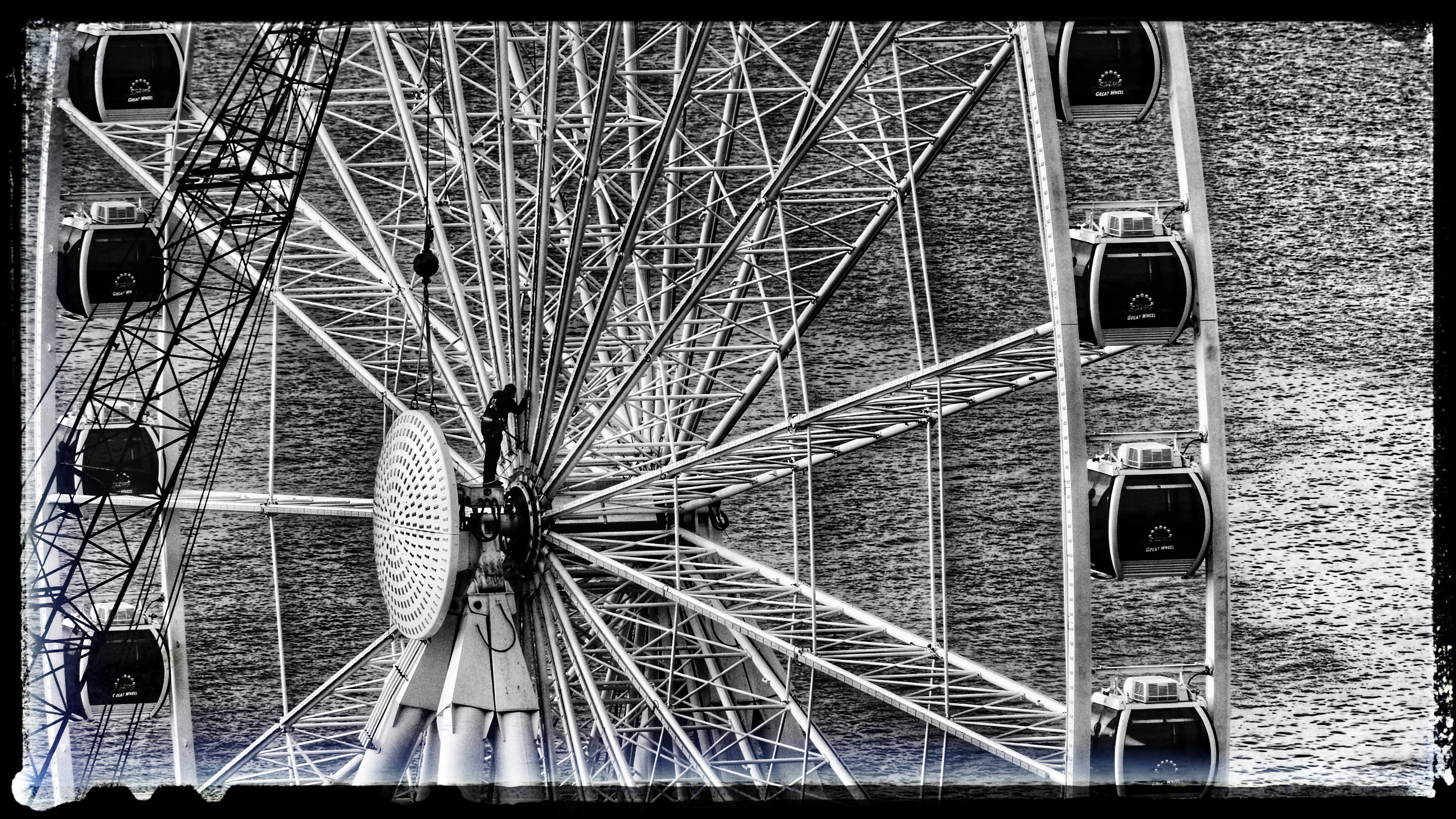 A construction worker places two new center plates onto the Seattle Grand.