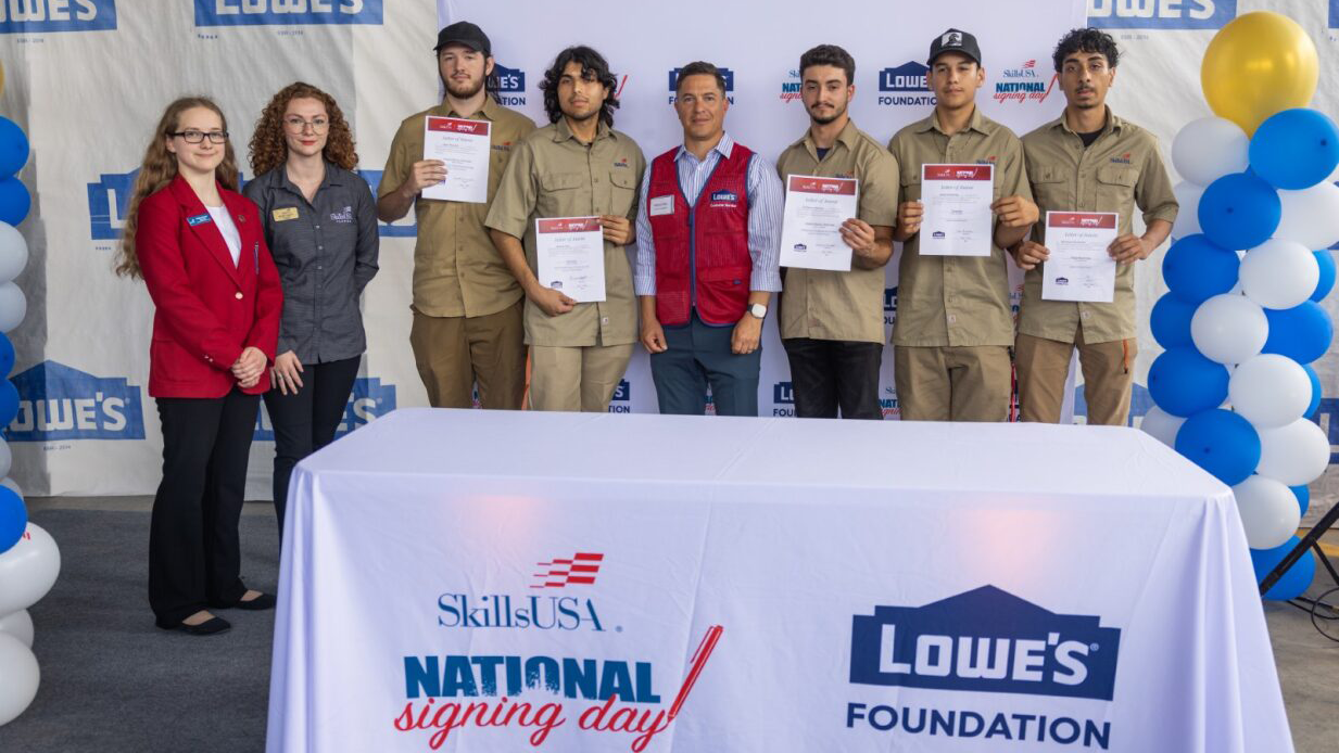 several students with their contracts at SkillsUSA National Signing Day and The Lowe's Foundation