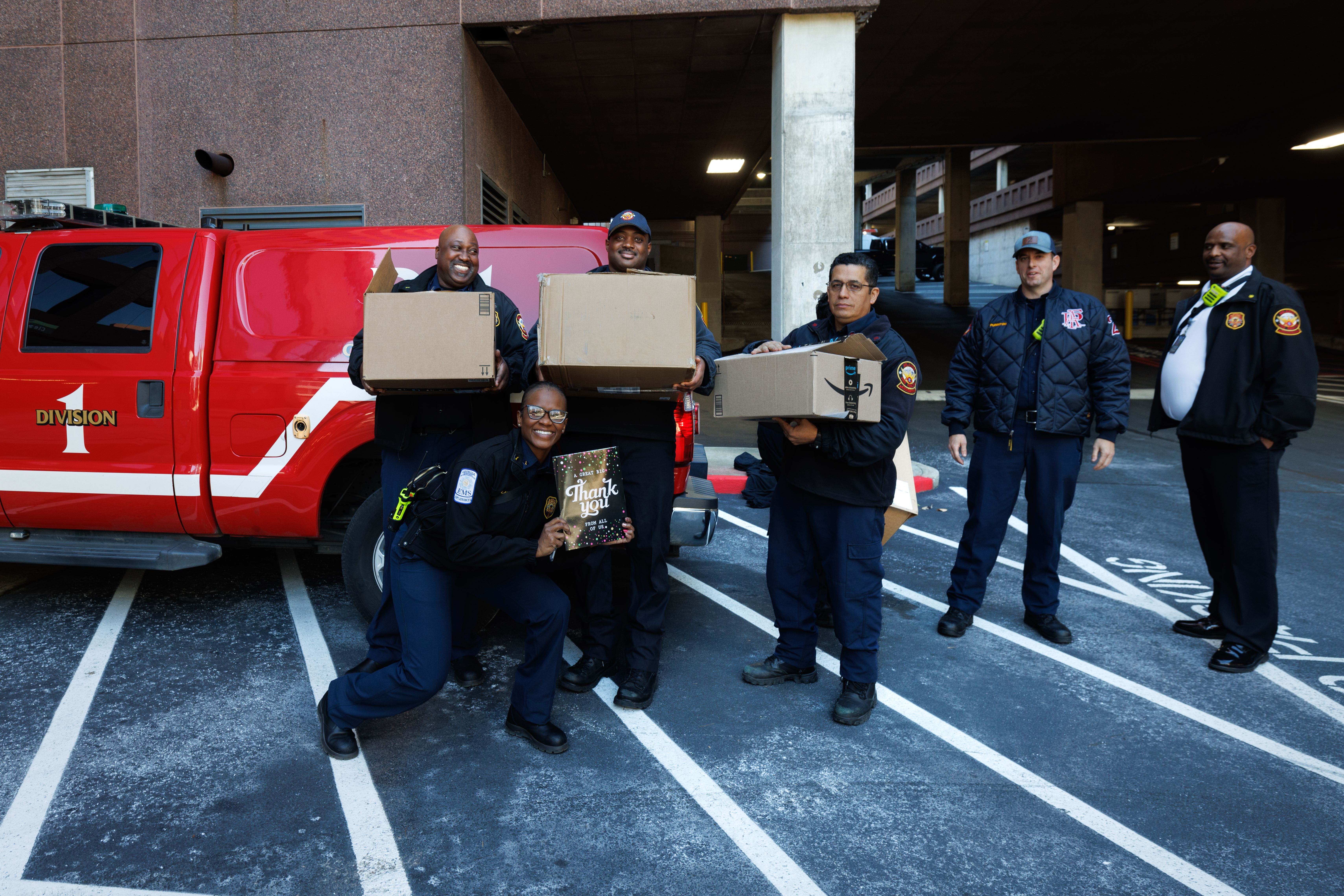 first responders holding boxes and smiling